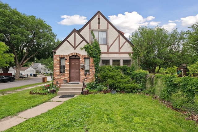 5801 23rd Ave S, Minneapolis, MN 55417 - english style home featuring a front lawn, brick siding, and stucco siding