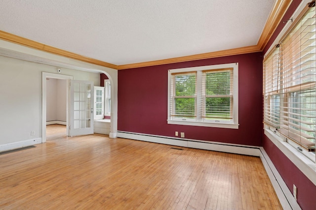 5801 23rd Ave S, Minneapolis, MN 55417 - empty room with ornamental molding, baseboard heating, light wood-type flooring, a textured ceiling, and arched walkways