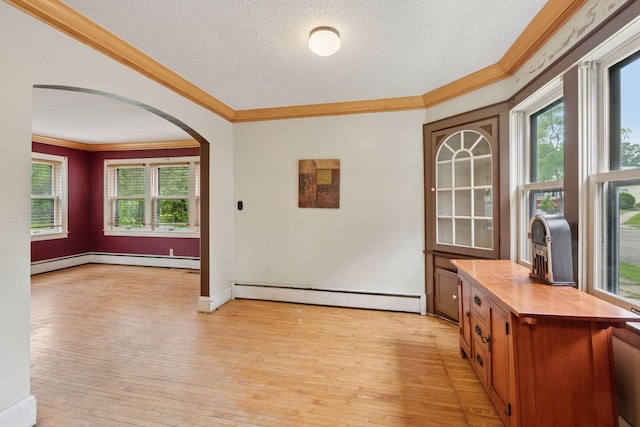 5801 23rd Ave S, Minneapolis, MN 55417 - unfurnished dining area with a baseboard heating unit, crown molding, arched walkways, a textured ceiling, and light wood-style floors