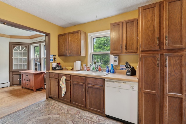 5801 23rd Ave S, Minneapolis, MN 55417 - kitchen with dishwasher, light countertops, brown cabinetry, crown molding, and a textured ceiling