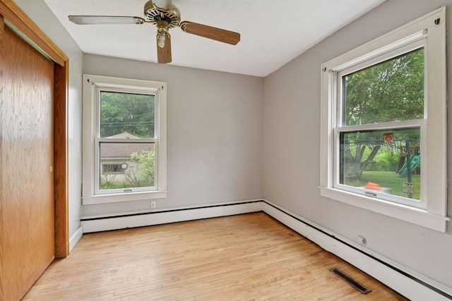5801 23rd Ave S, Minneapolis, MN 55417 - empty room with plenty of natural light, a baseboard radiator, light wood-style floors, and ceiling fan