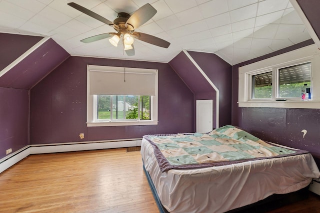 5801 23rd Ave S, Minneapolis, MN 55417 - bedroom featuring multiple windows, wood-type flooring, lofted ceiling, baseboard heating, and a ceiling fan
