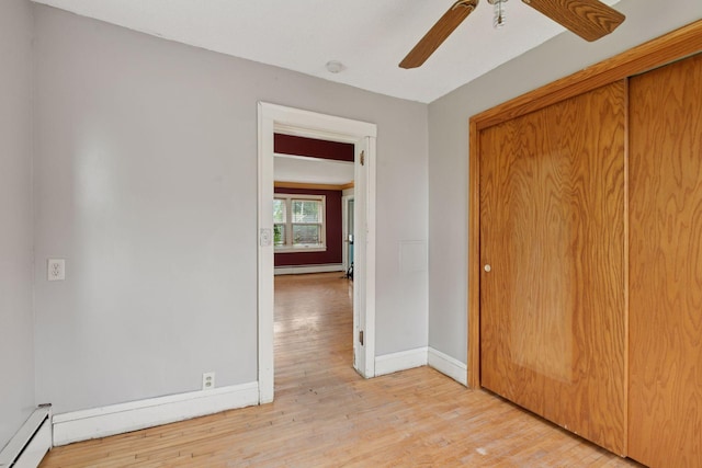 5801 23rd Ave S, Minneapolis, MN 55417 - unfurnished bedroom featuring a baseboard radiator, light wood-type flooring, a closet, and ceiling fan