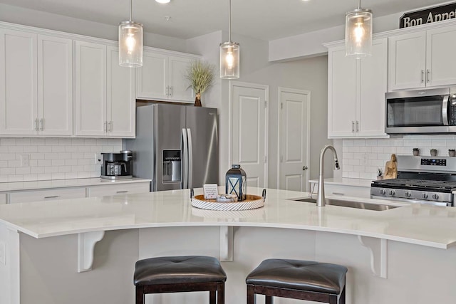 4884 Avery Ct, Eagan, MN 55123 - kitchen with stainless steel appliances, a sink, white cabinetry, and backsplash