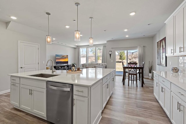 4884 Avery Ct, Eagan, MN 55123 - kitchen with dishwasher, a sink, light wood-style floors, recessed lighting, and light countertops