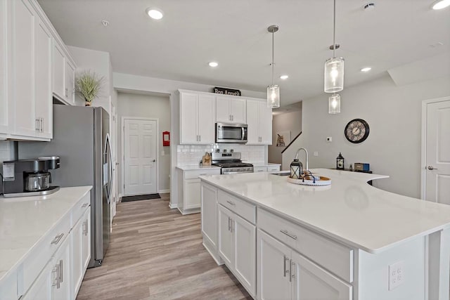 4884 Avery Ct, Eagan, MN 55123 - kitchen with appliances with stainless steel finishes, a sink, recessed lighting, backsplash, and white cabinetry