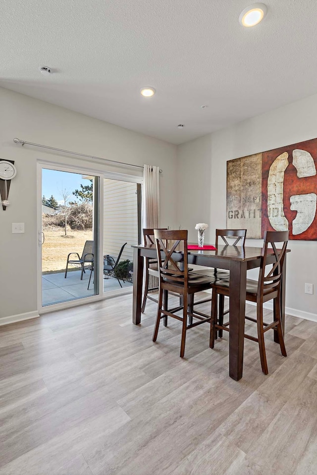 4884 Avery Ct, Eagan, MN 55123 - dining area featuring wood finished floors, baseboards, a textured ceiling, and recessed lighting