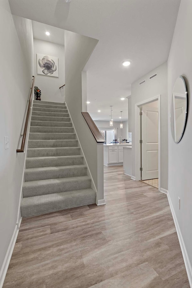 4884 Avery Ct, Eagan, MN 55123 - staircase featuring wood finished floors, baseboards, and recessed lighting