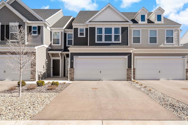 4884 Avery Ct, Eagan, MN 55123 - townhome / multi-family property featuring stone siding, a garage, driveway, and a shingled roof