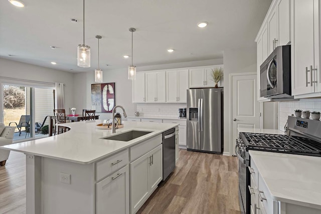 4884 Avery Ct, Eagan, MN 55123 - kitchen with stainless steel appliances, a sink, light wood-style flooring, light countertops, and backsplash