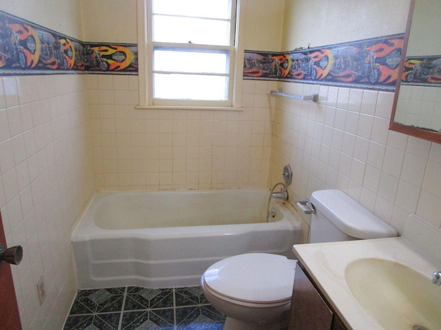 bathroom featuring tile walls, tile patterned flooring, a bathtub, vanity, and toilet