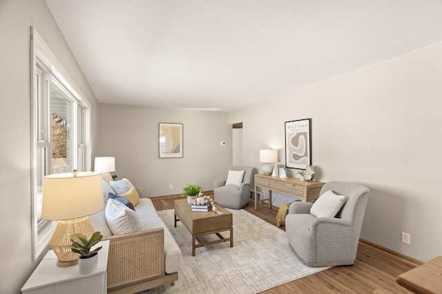 living room with light wood-style flooring and baseboards