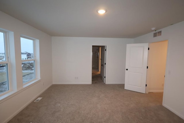 empty room featuring light carpet