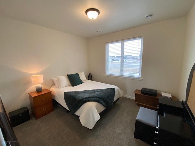 bedroom featuring dark colored carpet