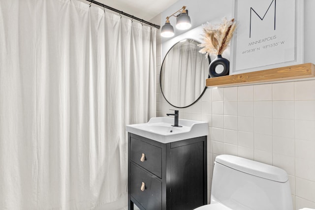 bathroom featuring vanity, toilet, a shower with shower curtain, and tile walls