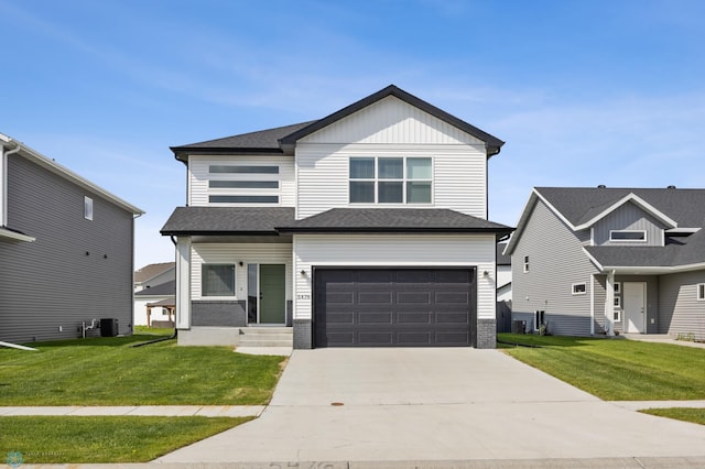 5476 Lori Ln W, West Fargo, ND 58078 - view of front facade featuring driveway, a front yard, an attached garage, and central air condition unit