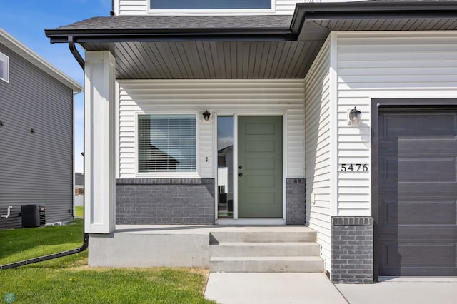 5476 Lori Ln W, West Fargo, ND 58078 - property entrance with cooling unit and a garage