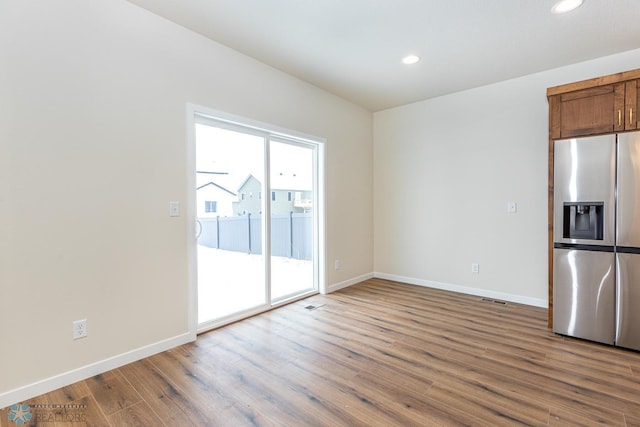 5476 Lori Ln W, West Fargo, ND 58078 - kitchen featuring stainless steel refrigerator with ice dispenser, wood finished floors, baseboards, and recessed lighting