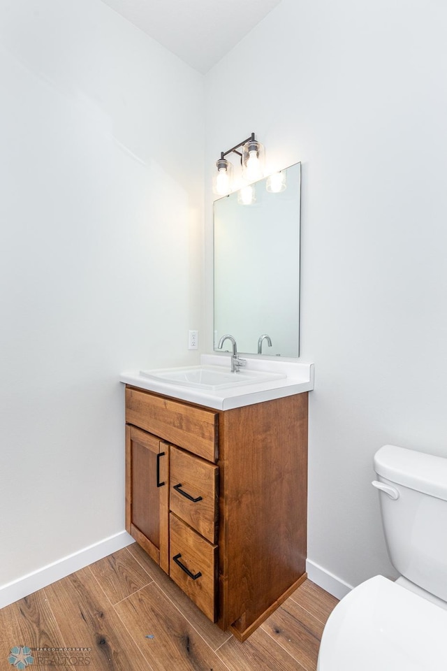 5476 Lori Ln W, West Fargo, ND 58078 - bathroom with vanity, toilet, wood finished floors, and baseboards