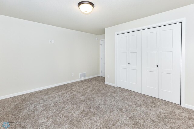 5476 Lori Ln W, West Fargo, ND 58078 - unfurnished bedroom with carpet flooring, a closet, and baseboards