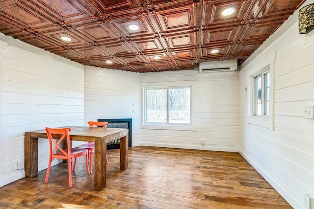 dining area featuring recessed lighting, an ornate ceiling, wood finished floors, and a wall unit AC