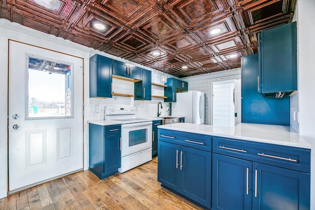 kitchen with light wood-type flooring, light countertops, white appliances, an ornate ceiling, and blue cabinets