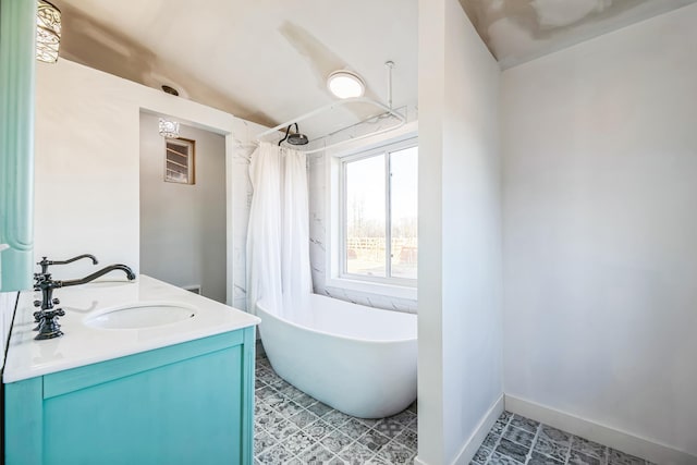 bathroom featuring baseboards, double vanity, a freestanding bath, a sink, and curtained shower