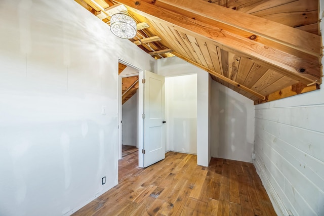 bonus room featuring lofted ceiling and light wood-style flooring