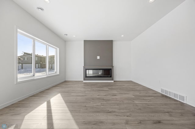 unfurnished living room featuring light wood-type flooring