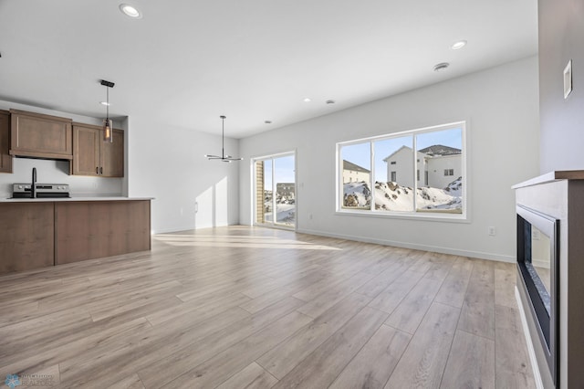 unfurnished living room with light wood-type flooring