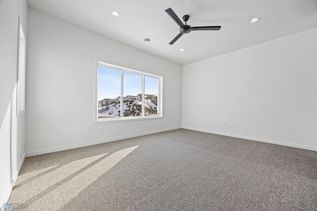 unfurnished room featuring ceiling fan and carpet flooring