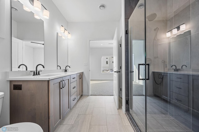 bathroom with vanity, an enclosed shower, and toilet