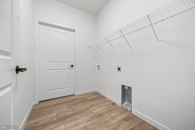 washroom with washer hookup, hookup for an electric dryer, and light wood-type flooring