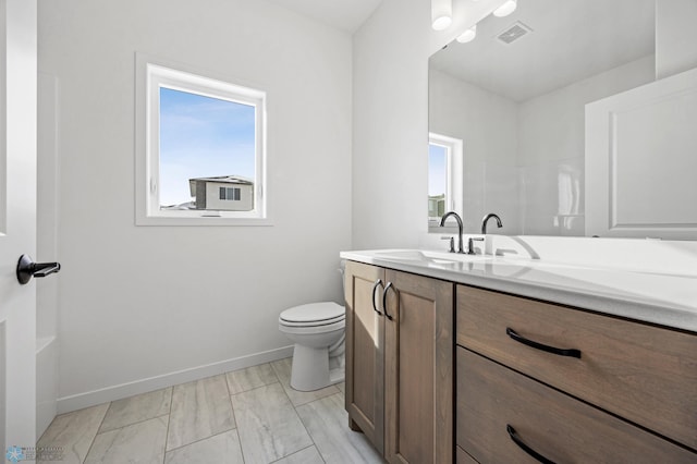 bathroom with vanity, walk in shower, and toilet