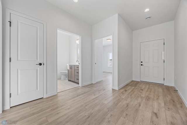 entrance foyer with visible vents, light wood finished floors, and baseboards