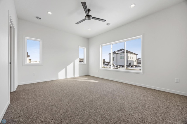 carpeted spare room with recessed lighting, visible vents, baseboards, and ceiling fan