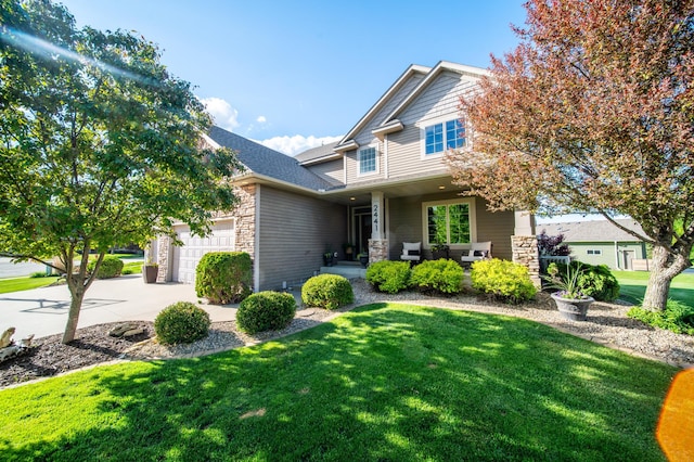 2441 Rosewood Ln SW, Rochester, MN 55902 - craftsman inspired home with stone siding, an attached garage, a front lawn, driveway, and a porch