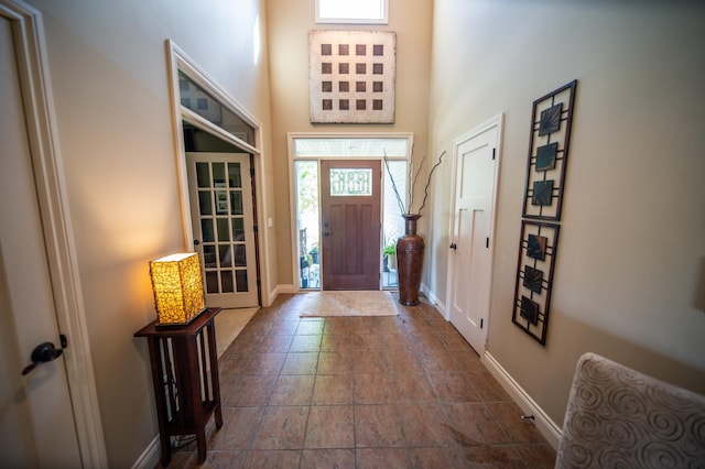 2441 Rosewood Ln SW, Rochester, MN 55902 - foyer with baseboards, a high ceiling, and dark stone finish flooring