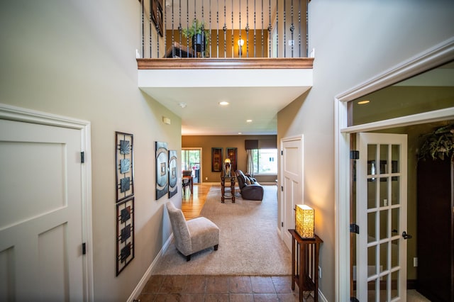 2441 Rosewood Ln SW, Rochester, MN 55902 - entryway featuring a high ceiling, dark colored carpet, recessed lighting, baseboards, and dark tile patterned floors