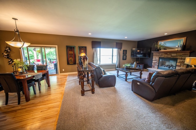 2441 Rosewood Ln SW, Rochester, MN 55902 - living area with light wood-style flooring, recessed lighting, a stone fireplace, and baseboards