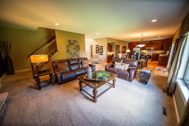 2441 Rosewood Ln SW, Rochester, MN 55902 - living area with light carpet, recessed lighting, baseboards, and stairs