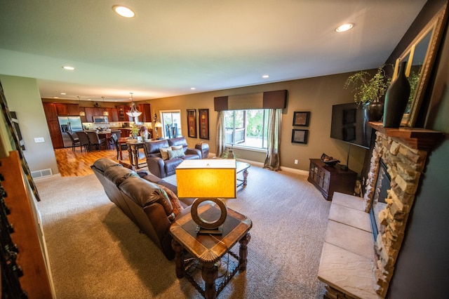 2441 Rosewood Ln SW, Rochester, MN 55902 - living area with recessed lighting, light carpet, baseboards, and a fireplace