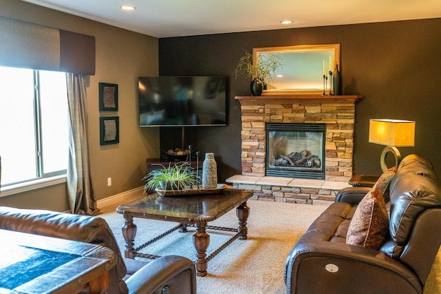 2441 Rosewood Ln SW, Rochester, MN 55902 - carpeted living area with healthy amount of natural light, recessed lighting, baseboards, and a stone fireplace