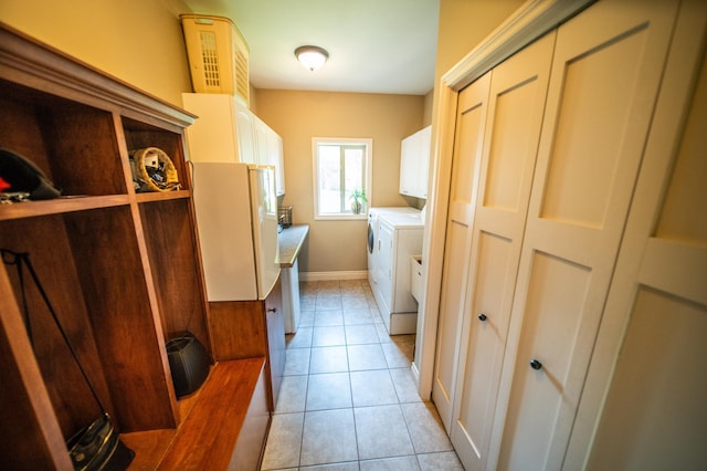2441 Rosewood Ln SW, Rochester, MN 55902 - washroom with cabinet space, independent washer and dryer, light tile patterned floors, and baseboards