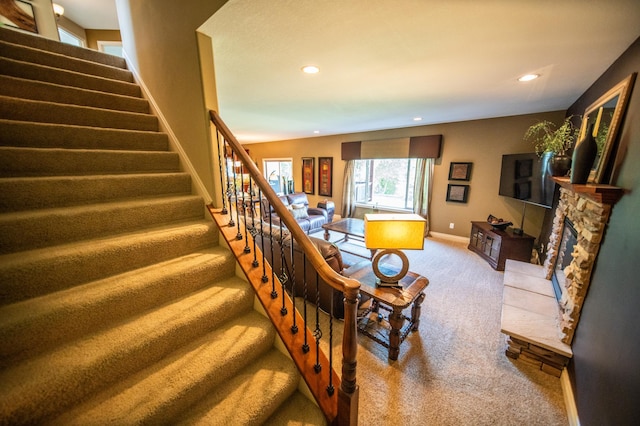 2441 Rosewood Ln SW, Rochester, MN 55902 - staircase featuring carpet flooring, recessed lighting, a fireplace, and baseboards