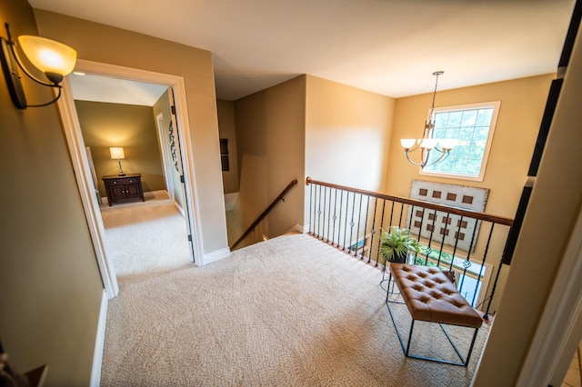 2441 Rosewood Ln SW, Rochester, MN 55902 - hallway featuring a chandelier, an upstairs landing, carpet, and baseboards