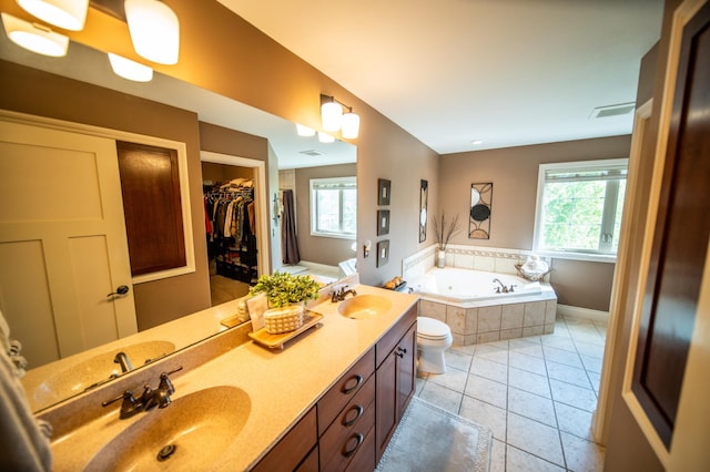 2441 Rosewood Ln SW, Rochester, MN 55902 - full bath featuring healthy amount of natural light, a bath, double vanity, and tile patterned floors