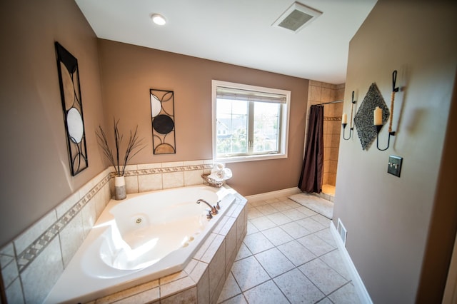 2441 Rosewood Ln SW, Rochester, MN 55902 - bathroom with a tub with jets, a tile shower, and tile patterned flooring