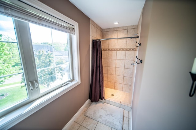 2441 Rosewood Ln SW, Rochester, MN 55902 - bathroom featuring a tile shower, healthy amount of natural light, tile patterned flooring, and recessed lighting