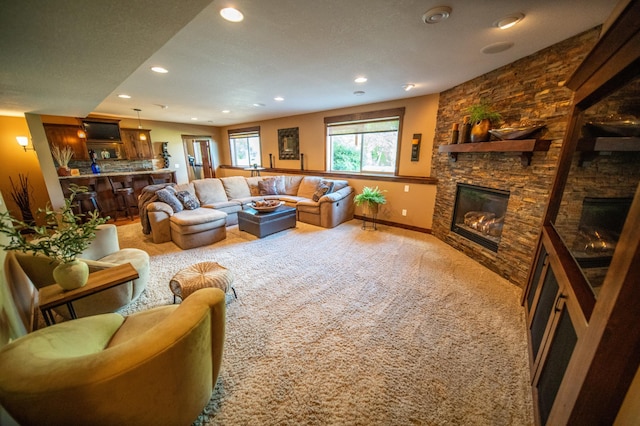 2441 Rosewood Ln SW, Rochester, MN 55902 - living room with a stone fireplace, carpet floors, recessed lighting, and baseboards